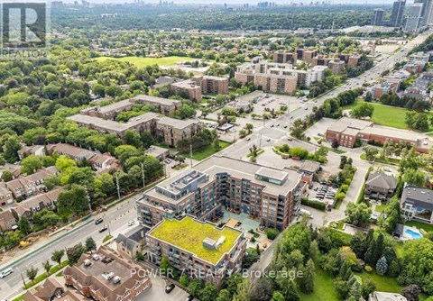 An aerial view of a residential area with apartment buildings and green spaces.