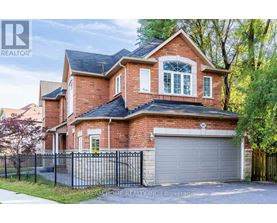 A brick house with a black fence and a garage door.