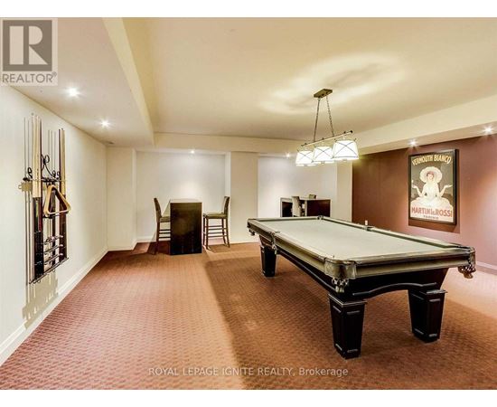 A pool table in a room with a poster on the wall.
