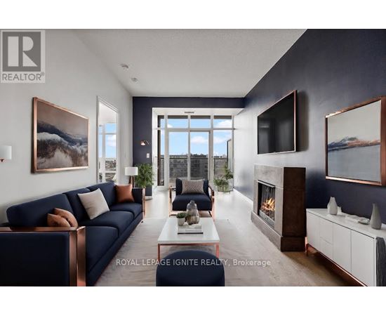 A modern living room with a dark blue sofa and a fireplace.
