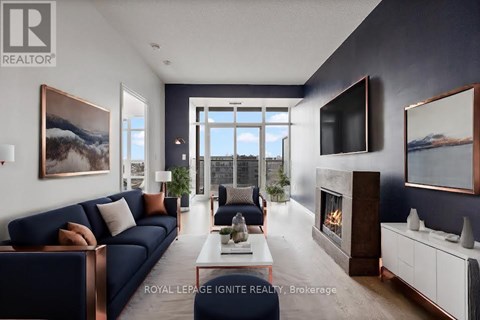 A modern living room with a dark blue sofa and a fireplace.
