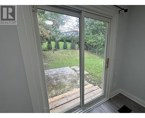 A sliding glass door with a view of a backyard.