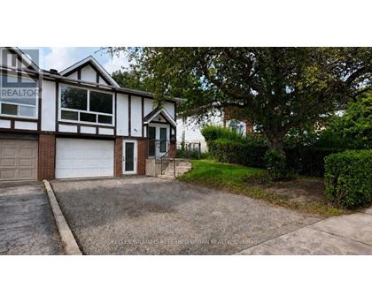 A house with a driveway in front of it.