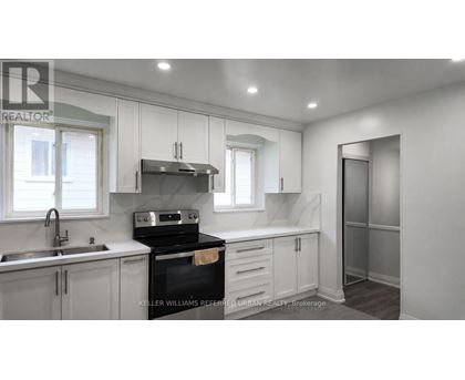 A kitchen with a stove top oven and a sink.