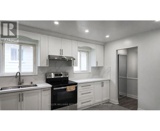 A kitchen with a stove top oven and a sink.