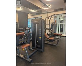 A gym with a row of exercise machines.