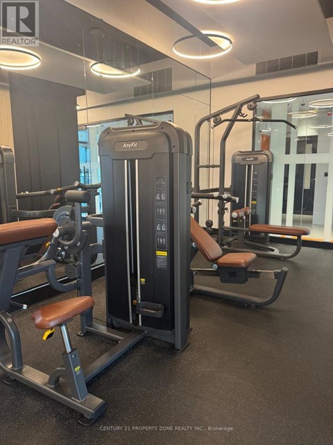 A gym with a row of exercise machines.