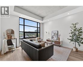 A modern bedroom with a large bed and a view of the city.