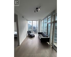 A spacious room with a view of the cityscape outside the large windows.
