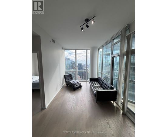A spacious room with a view of the cityscape outside the large windows.