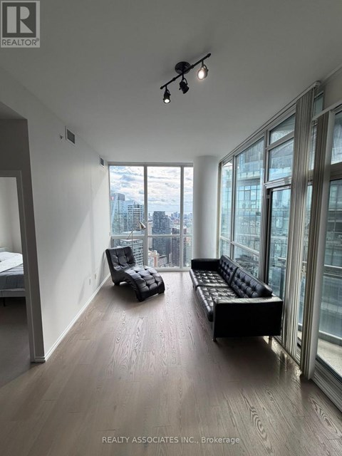 A spacious room with a view of the cityscape outside the large windows.
