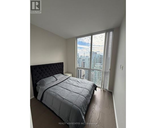 A bedroom with a large bed and a view of the city.