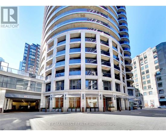 A tall white building with a blue stripe on the side and a sign that says REALTOR.