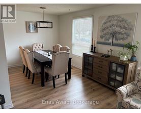 A dining room with a table set for six.