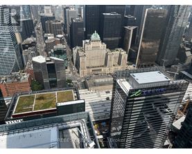 A cityscape with a green roofed building in the center.