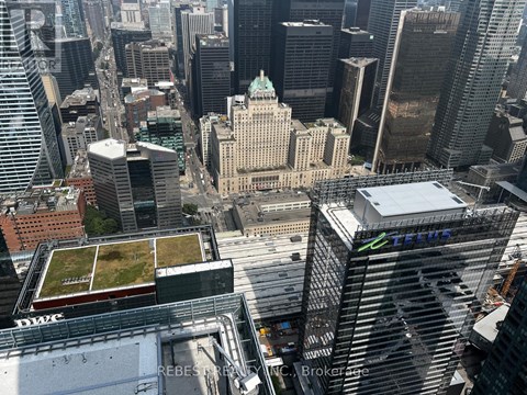 A cityscape with a green roofed building in the center.