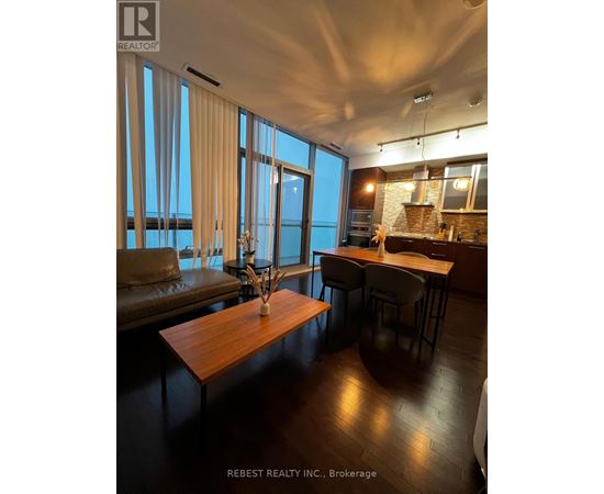A modern kitchen with a dining table and chairs.