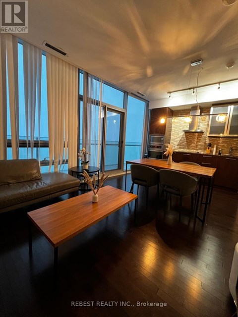A modern kitchen with a dining table and chairs.
