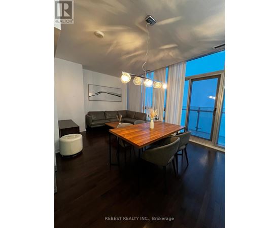 A modern dining room with a wooden table and chairs.