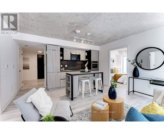 A modern living room with a grey couch and a coffee table.