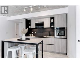 A modern kitchen with a black and white color scheme.