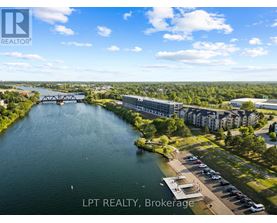 A real estate company logo is displayed on an aerial view of a riverfront property.