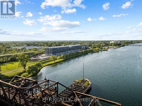A river flows through a city with a bridge in the foreground.