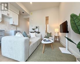 A well-lit, spacious bedroom with a large bed and a small coffee table.
