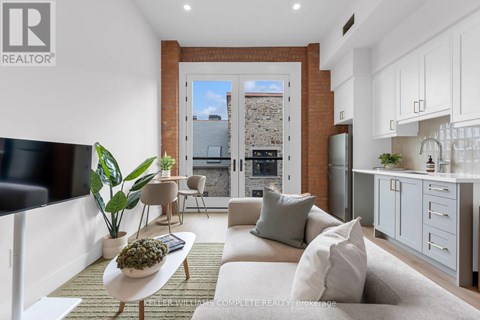 A well-lit, spacious bedroom with a large bed and a small coffee table.
