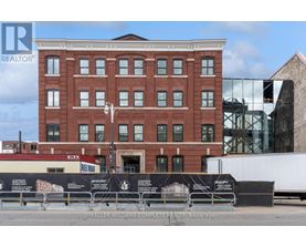 A brick building with a sign that says Keller Williams Complete Realty Brokerage.