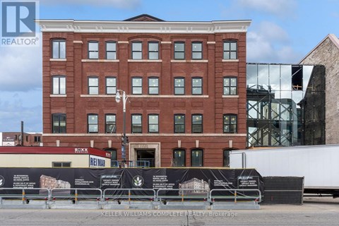 A brick building with a sign that says Keller Williams Complete Realty Brokerage.
