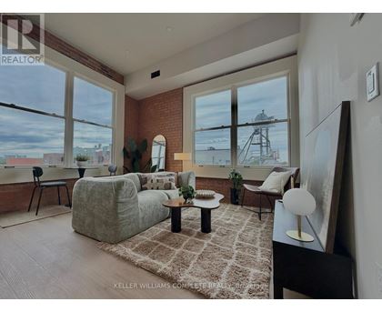 A living room with a large window overlooking a water tower.