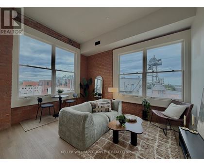 A living room with a couch, chair, and coffee table.