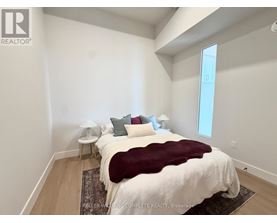 A bedroom with a large bed and a window.