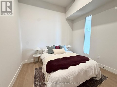 A bedroom with a large bed and a window.