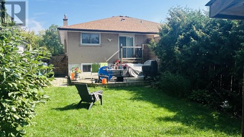 A house with a patio and a table in the backyard.