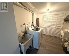 A small, white laundry room with a washer and dryer.