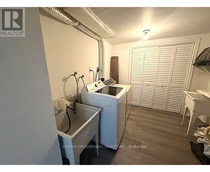A small, white laundry room with a washer and dryer.