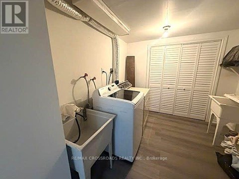 A small, white laundry room with a washer and dryer.