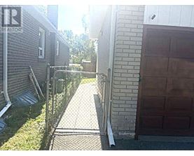 A backyard with a fence and a garage door.