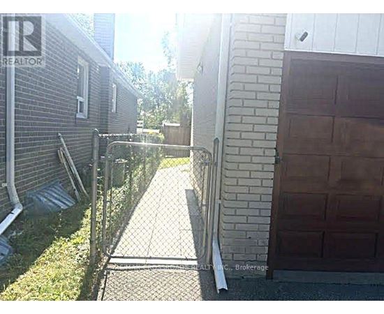 A backyard with a fence and a garage door.