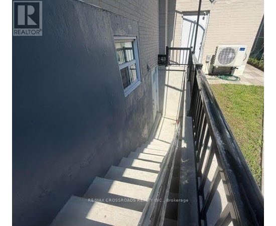 A concrete staircase leading to a door with a window.