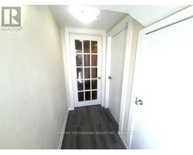 A hallway with a door and a window.