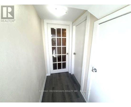 A hallway with a door and a window.