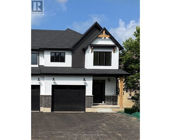 A modern house with a black and white exterior and a brick chimney.