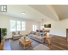 A living room with a couch, chairs, and a coffee table.