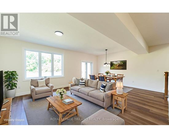 A living room with a couch, chairs, and a coffee table.