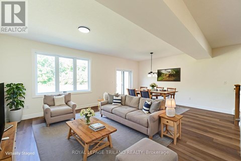 A living room with a couch, chairs, and a coffee table.