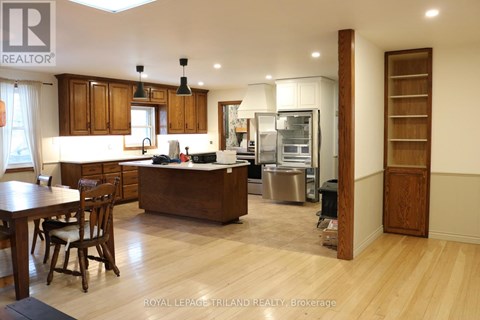 A kitchen with wooden cabinets and a dining table.