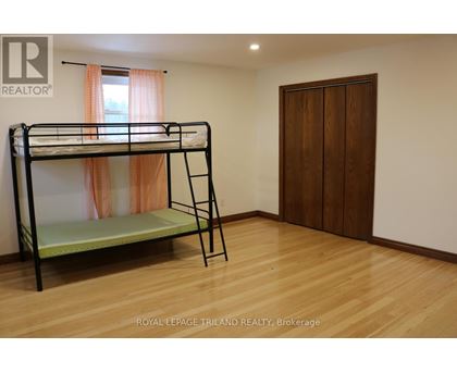 A bedroom with a bunk bed and a wooden door.